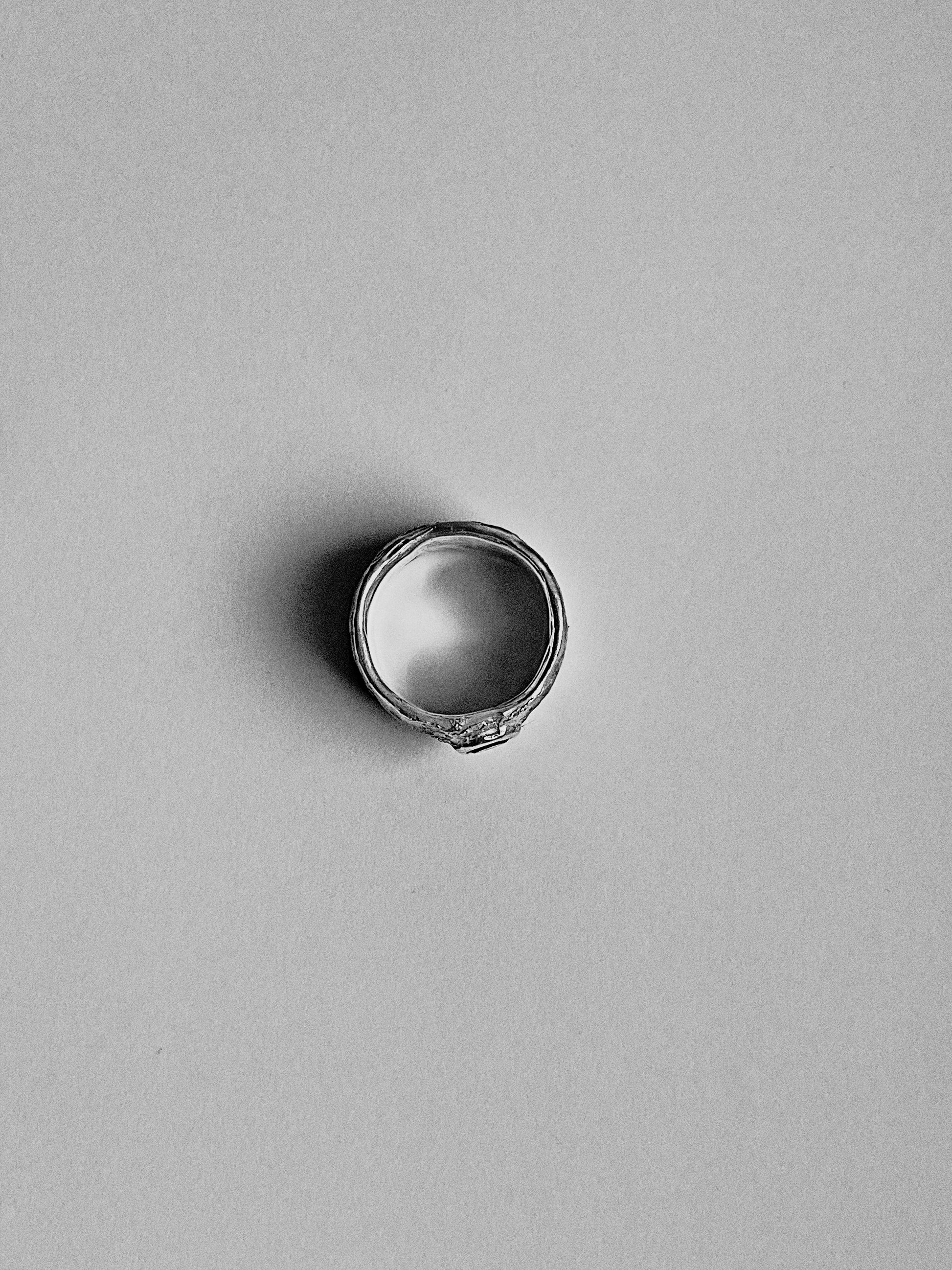 Silver ring on a gray background