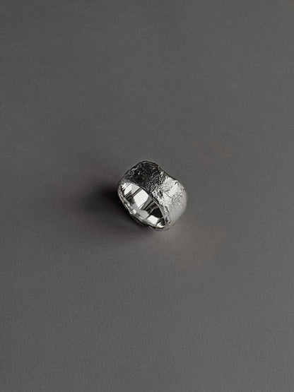 a wide and heavy textured ring